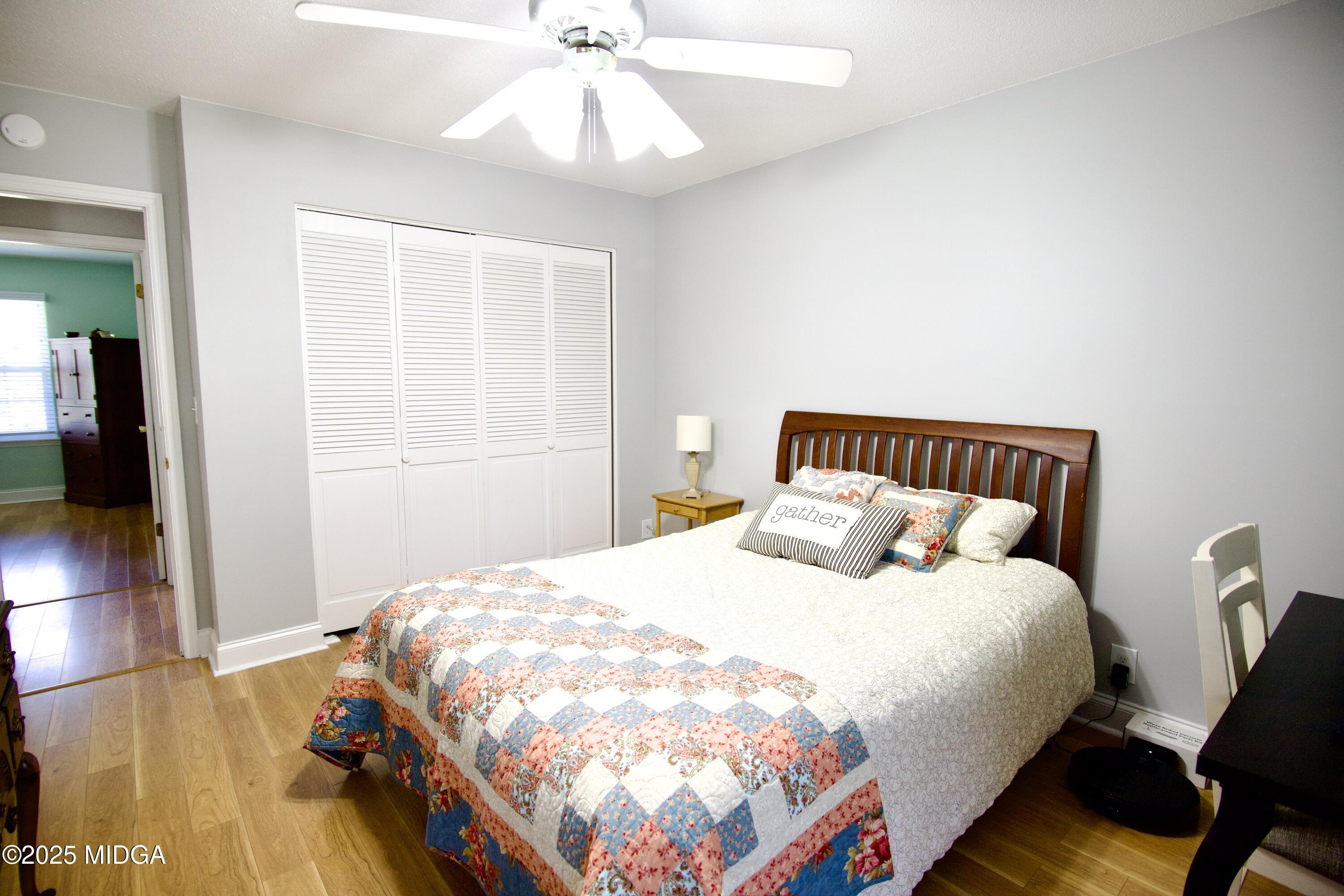 1205 Morningside Drive Perry, GA 31069 - Photo 19 of 31 a bedroom with a bed and wooden floor