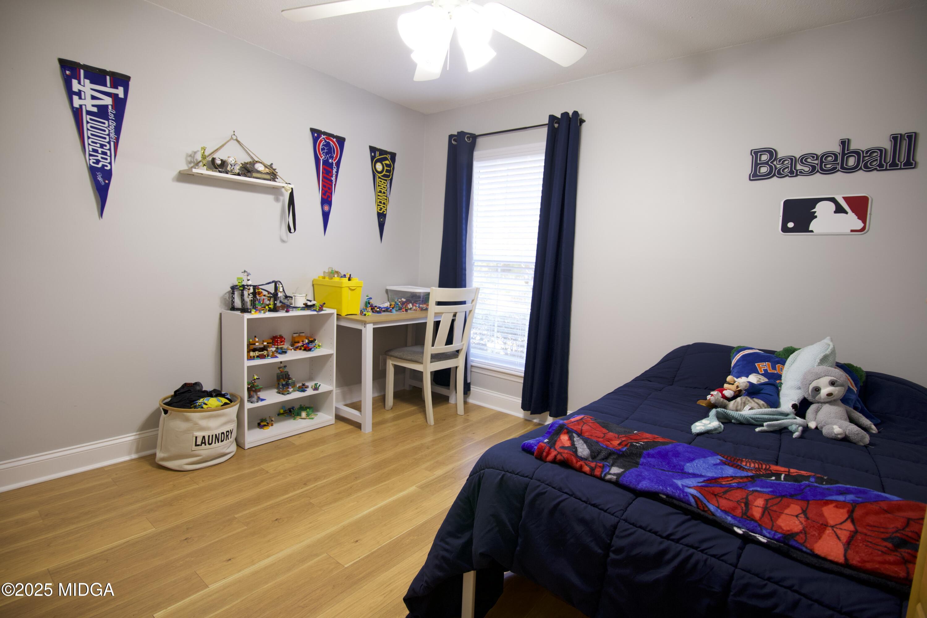 1205 Morningside Drive Perry, GA 31069 - Photo 20 of 31 a bedroom with a bed and wooden floor
