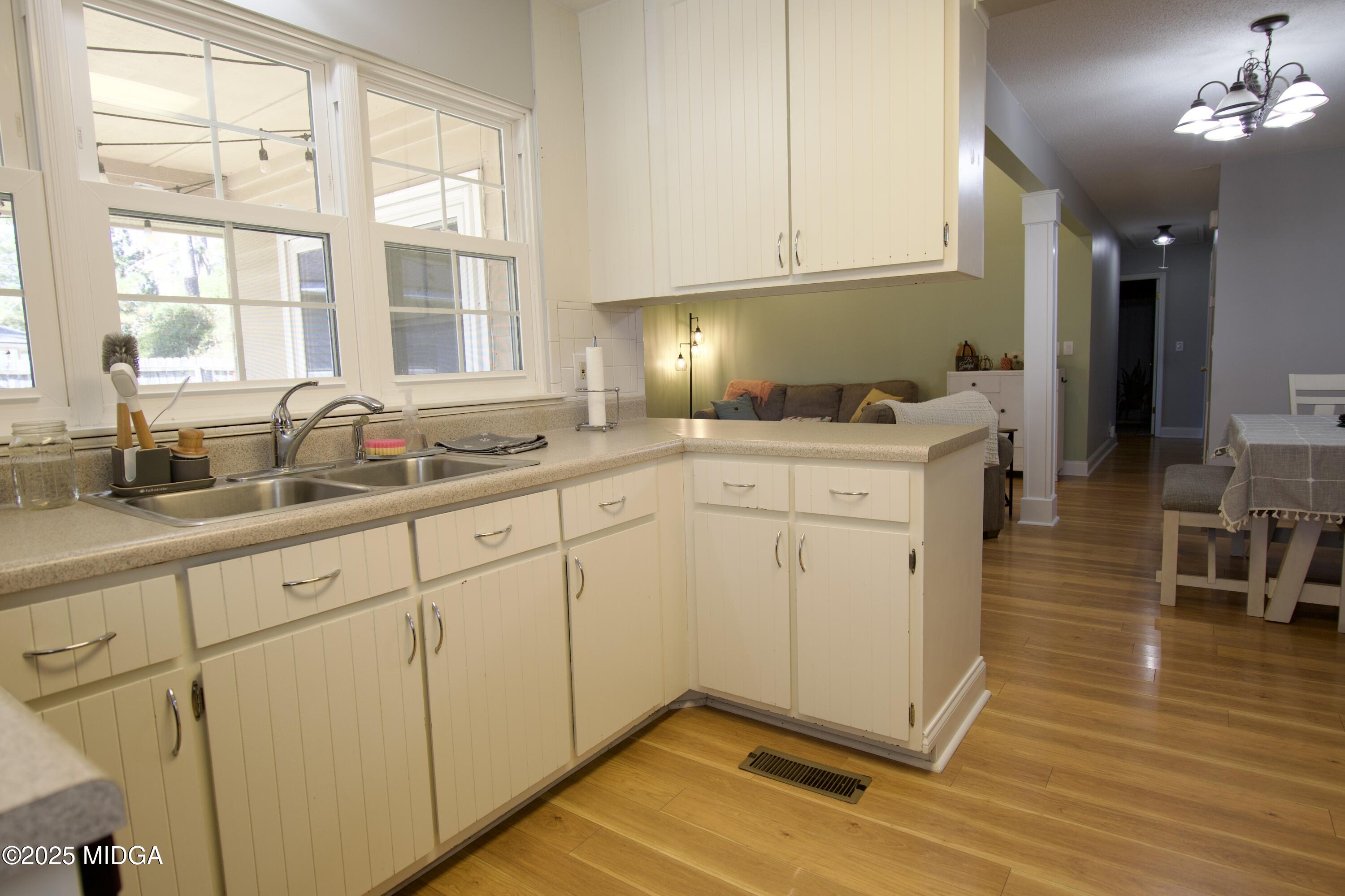 1205 Morningside Drive Perry, GA 31069 - Photo 7 of 31 a kitchen with stainless steel appliances granite countertop a sink window and cabinets