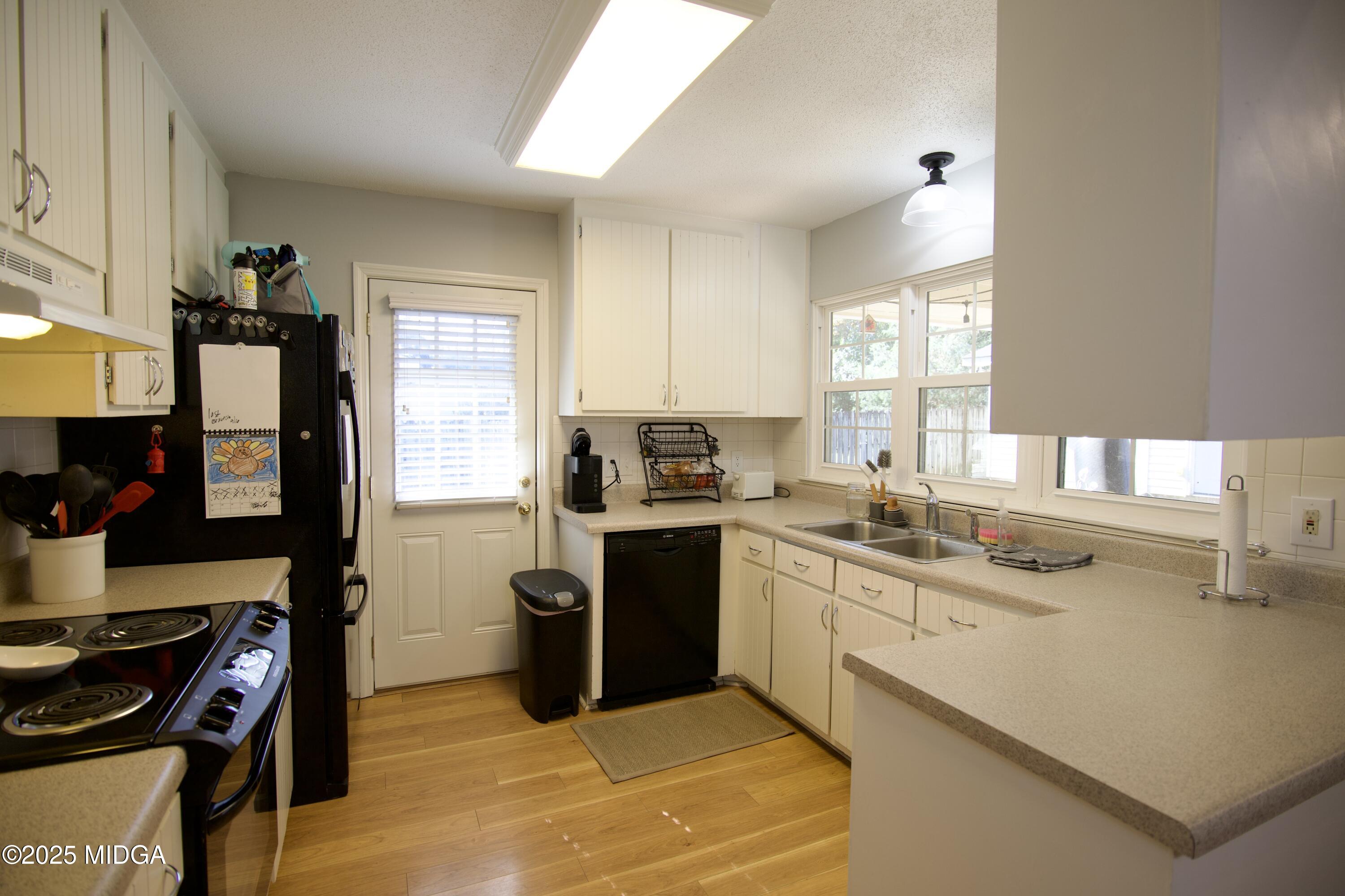 1205 Morningside Drive Perry, GA 31069 - Photo 8 of 31 a kitchen with a sink stove top oven and cabinets