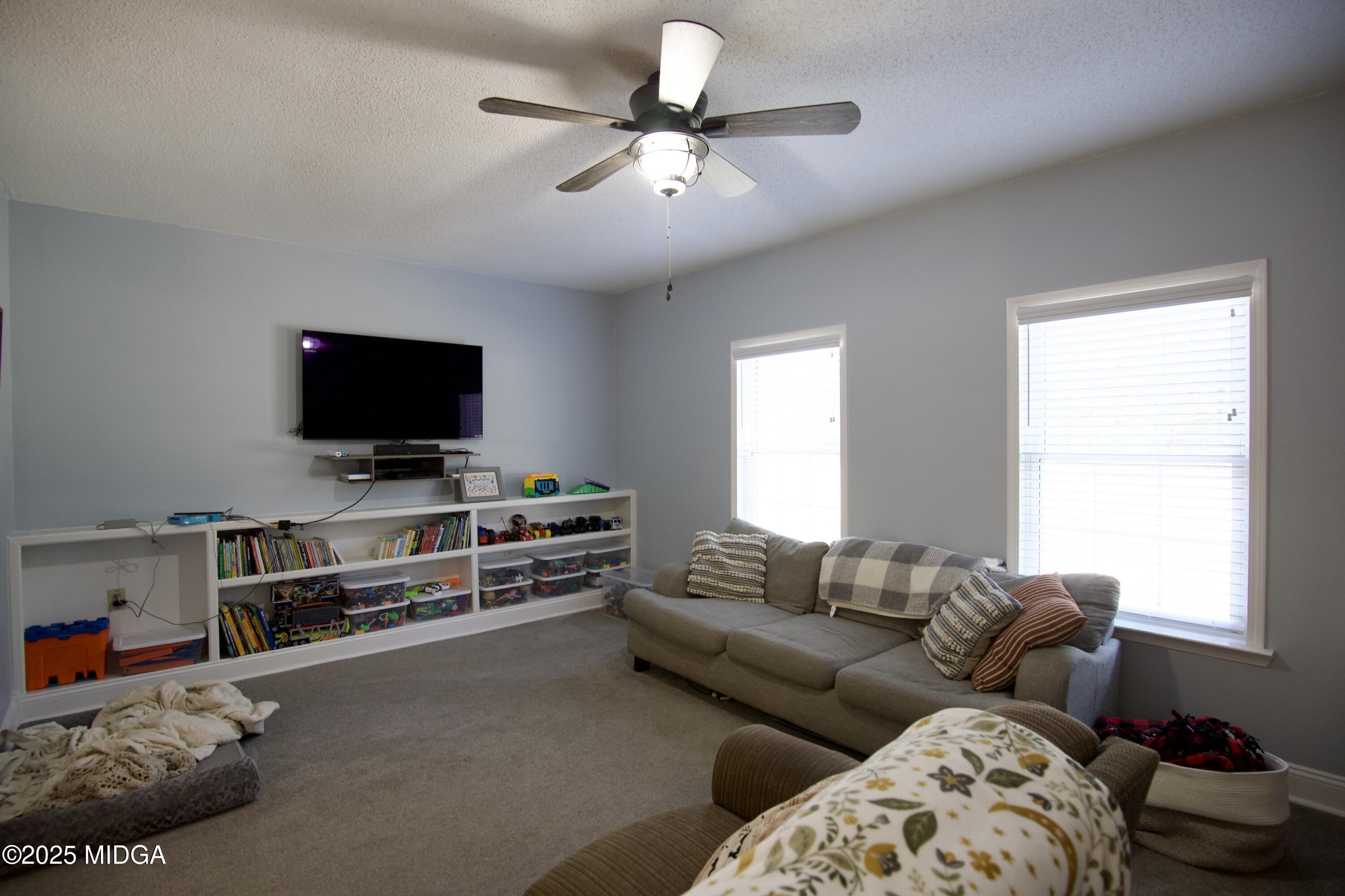 1205 Morningside Drive Perry, GA 31069 - Photo 10 of 31 a living room with furniture and a flat screen tv