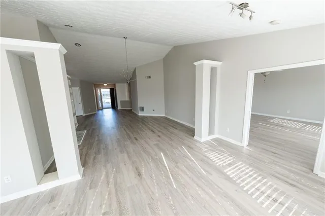 a view of a room with wooden floor and staircase