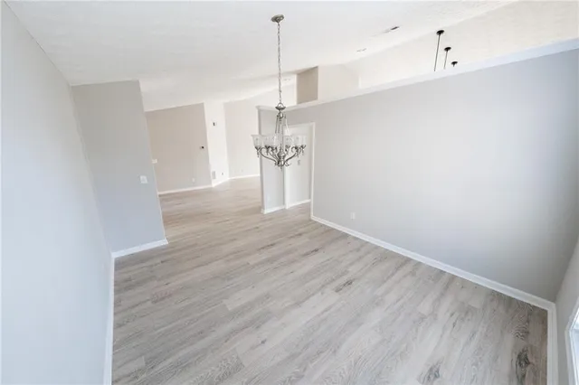 a view of a kitchen with wooden floor and a ceiling fan