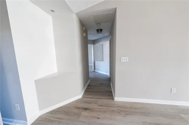 a view of a hallway with wooden floor