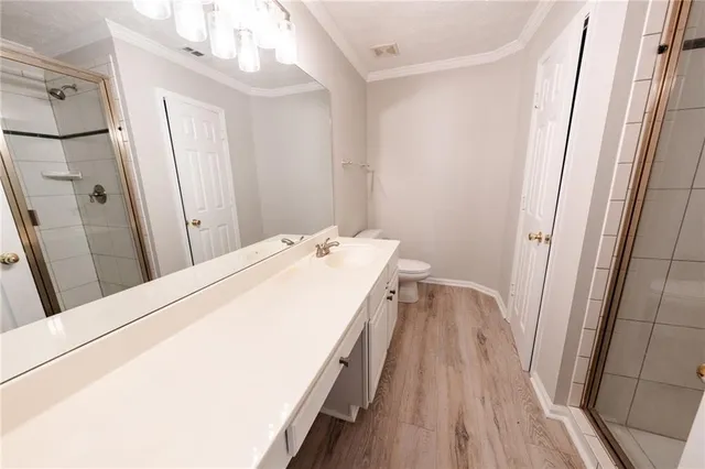 a view of a bathroom with a sink and wooden floor