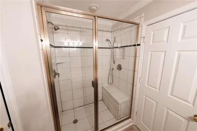 a bathroom with a glass shower door