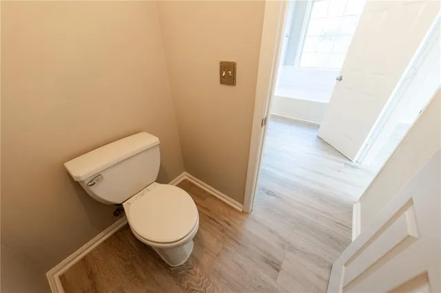 a white toilet sitting next to a shower