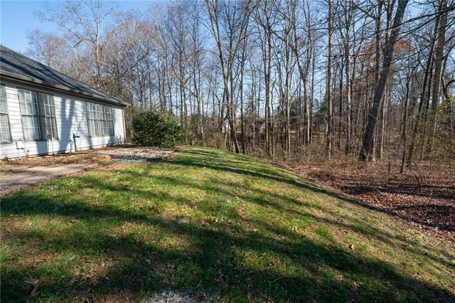a backyard of a house with a yard and outdoor seating