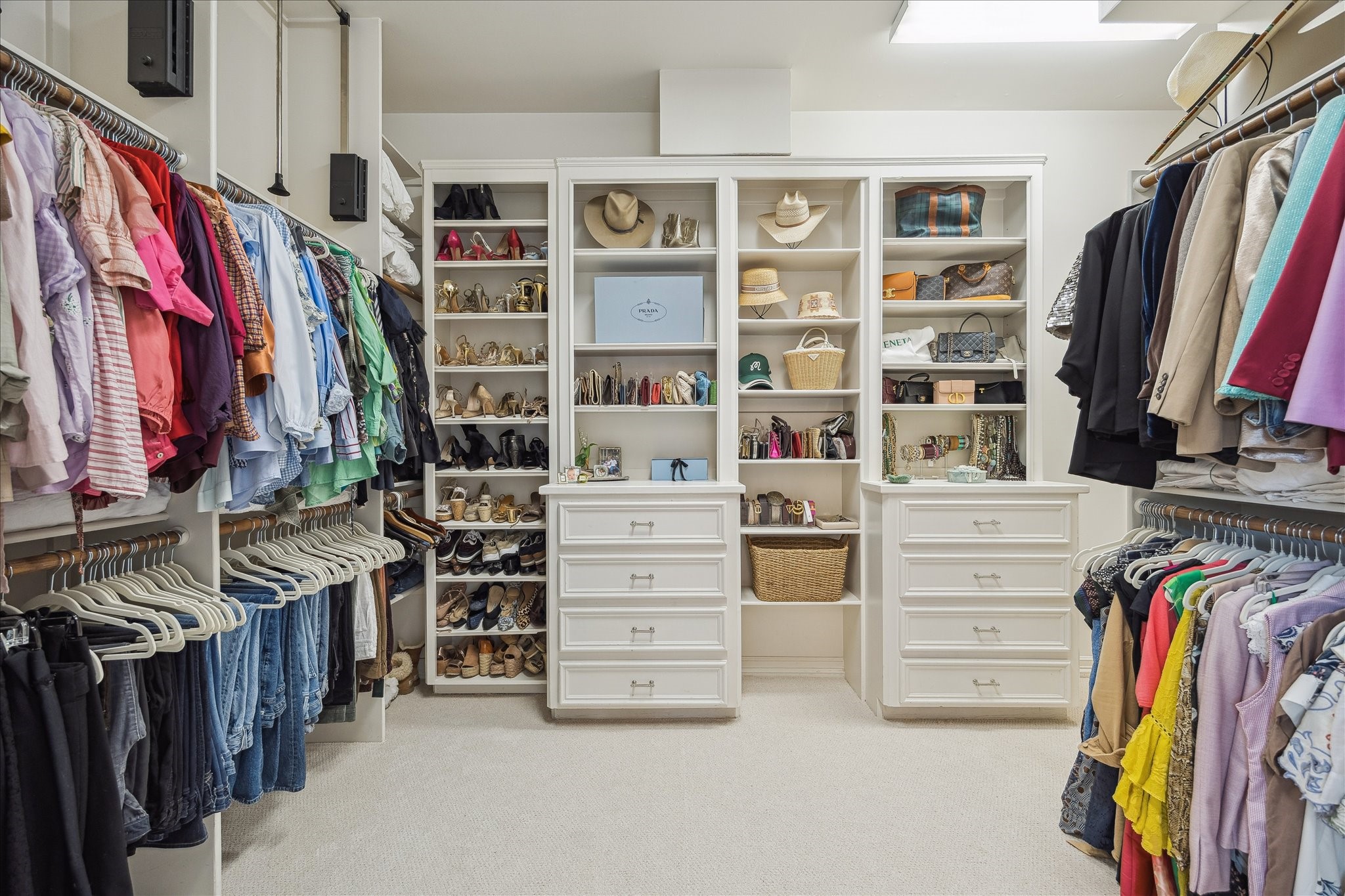 11524 Taylorcrest Road Houston, TX 77024 - Photo 29 of 47 The spacious walk-in primary closet features built-in cabinetry, shoe storage, drawers, and pull-down hanging racks that maximize storage all the way to the ceiling.