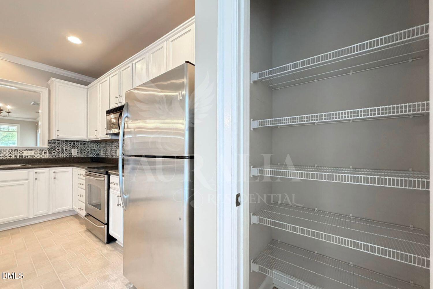 7754 ACC Boulevard Raleigh, NC 27617 - Photo 13 of 41 a walk in closet with white cabinets