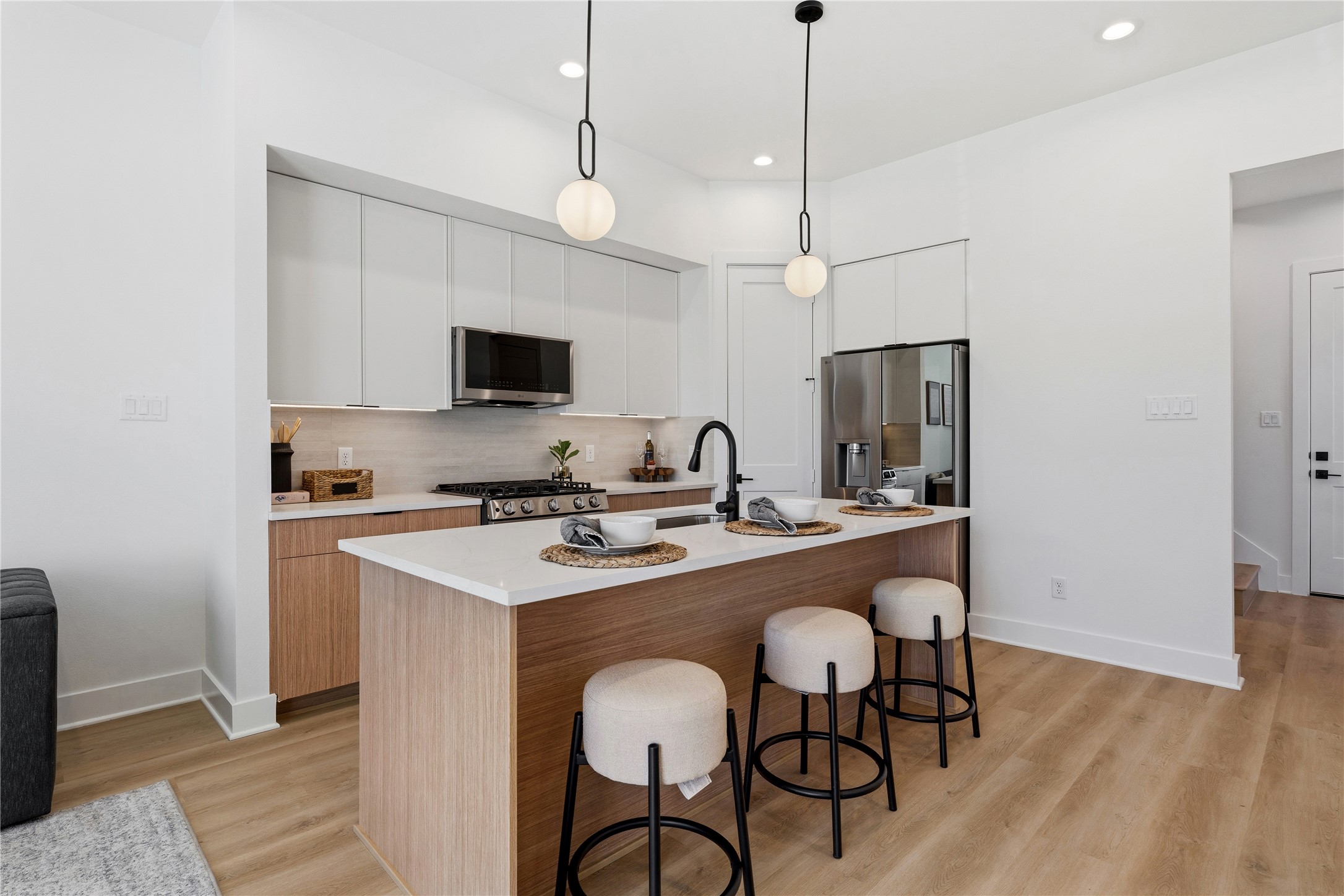 4610 Gunter Street Houston, TX 77020 - Photo 5 of 43 a kitchen with stainless steel appliances granite countertop a sink a stove a refrigerator a dining table and chairs with wooden floor