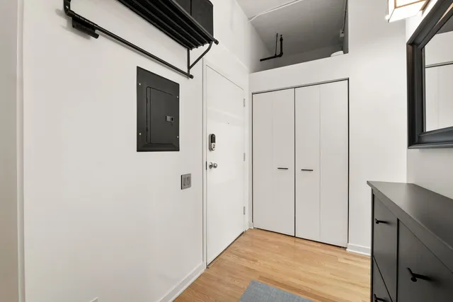a view of a hallway with wooden floor and staircase