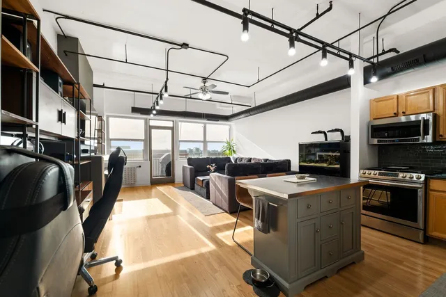 a kitchen with stainless steel appliances granite countertop a stove a refrigerator a sink and dishwasher