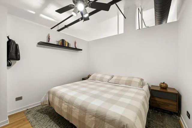 a bedroom with a bed and a ceiling fan
