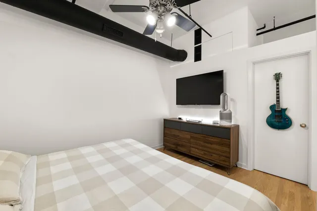 a bedroom with furniture and flat screen tv