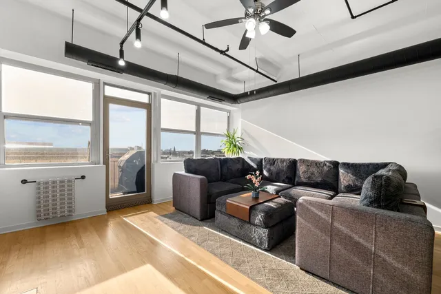 a living room with furniture and a floor to ceiling window