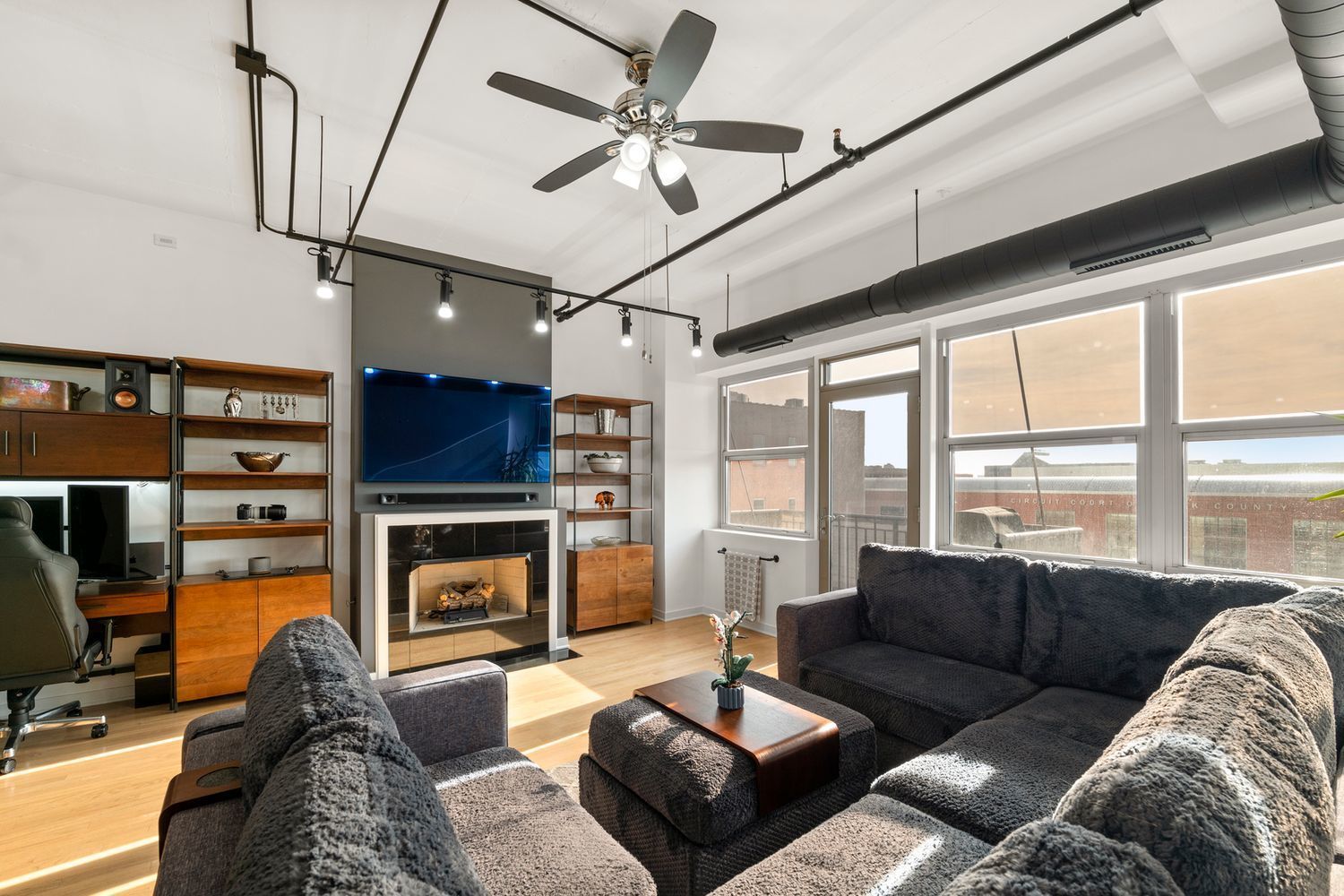 500 South Clinton Street, Unit 624 Chicago, IL 60607 - Photo 10 of 37 a living room with furniture a fireplace and a flat screen tv