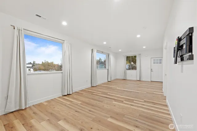 a view of a bedroom with a bed and a window