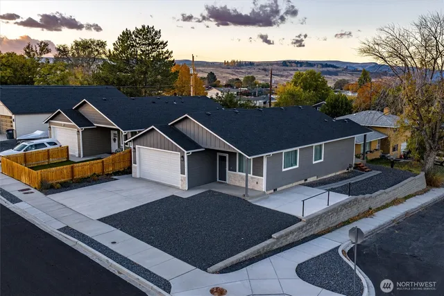 a aerial view of a house next to a big yard
