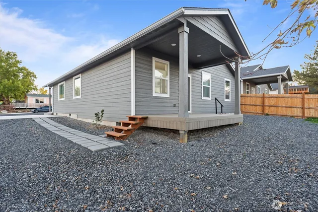 a backyard of a house with barbeque oven