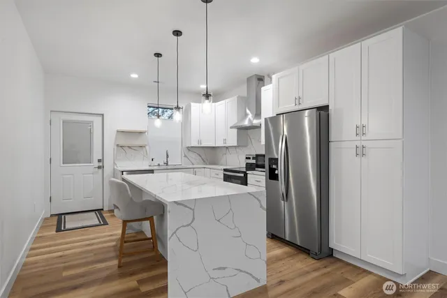 a kitchen with a refrigerator a sink and a stove
