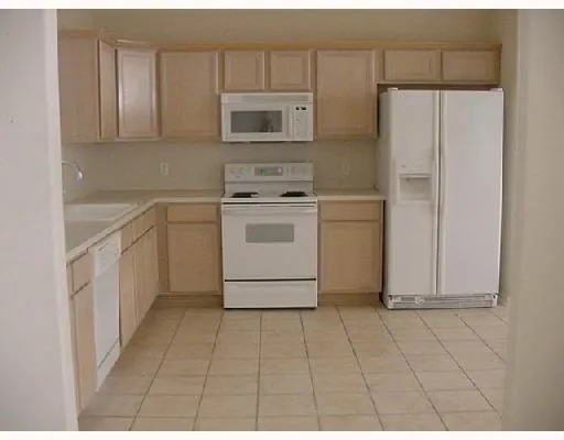 a kitchen with cabinets and steel appliances