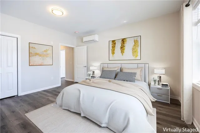 a bedroom with a bed and painting on the wall