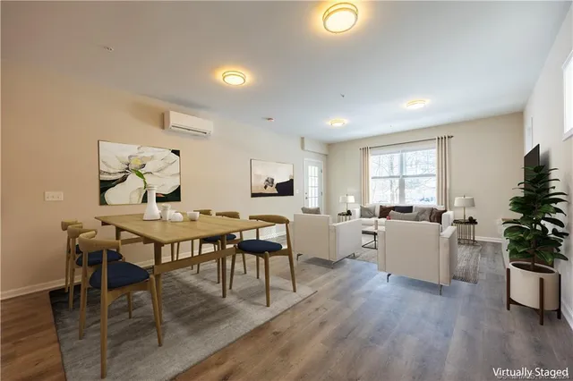 a view of a dining room with furniture and wooden floor