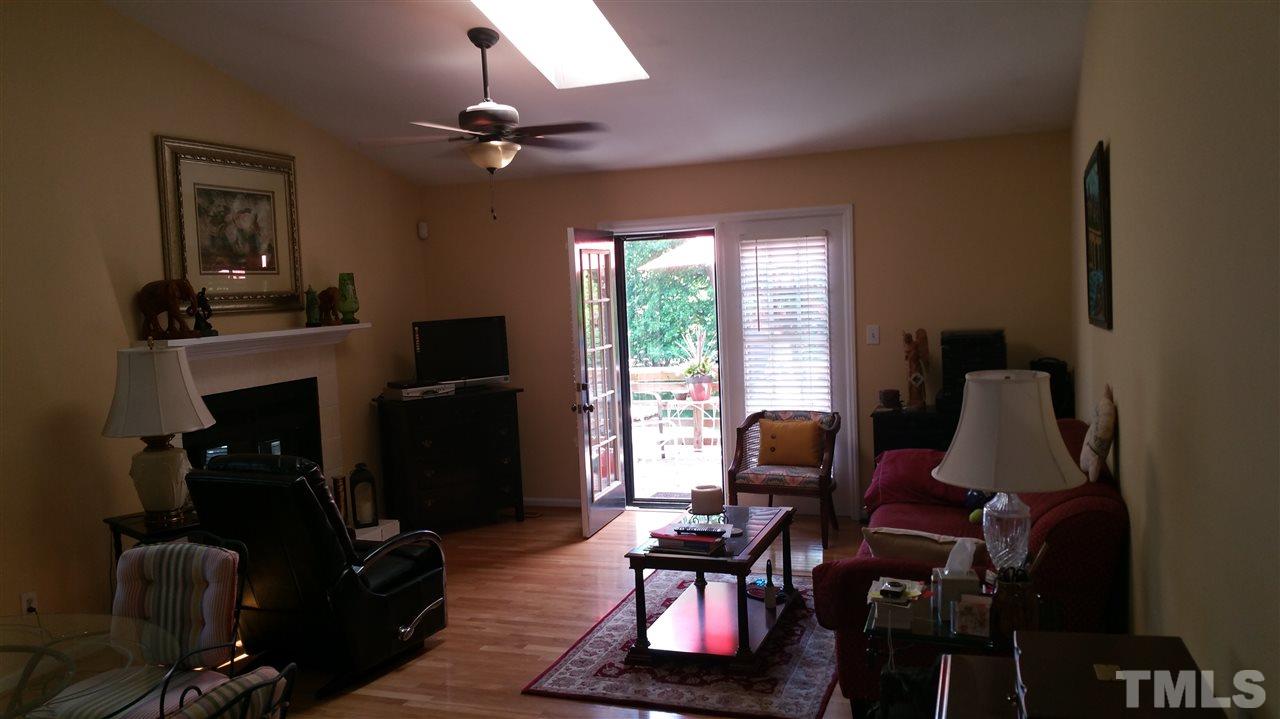 1420 Mapleside Court Raleigh, NC 27609 - Photo 3 of 25 a living room with furniture and a fireplace