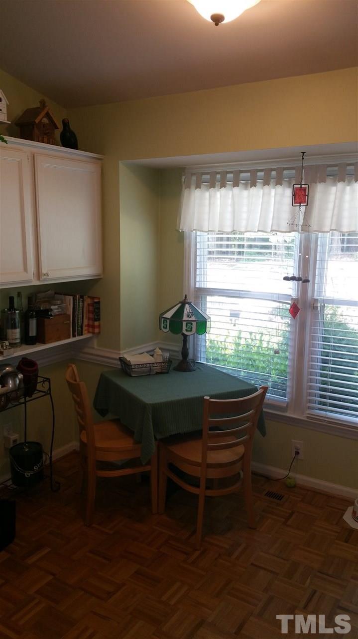 1420 Mapleside Court Raleigh, NC 27609 - Photo 8 of 25 a table room with a chair and a window