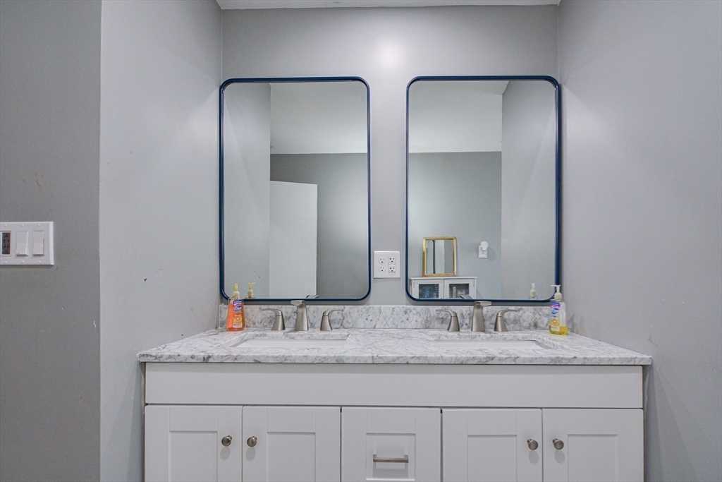 35 Worcester Street Methuen, MA 01844 - Photo 12 of 31 a bathroom with double vanity sinks and a mirror