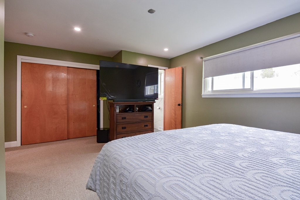 35 Worcester Street Methuen, MA 01844 - Photo 16 of 31 a bedroom with a bed and a flat screen tv