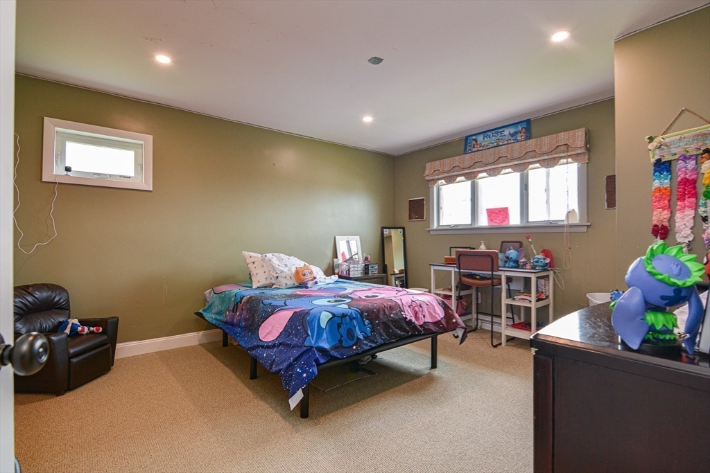 35 Worcester Street Methuen, MA 01844 - Photo 20 of 31 a bedroom with a bed and a potted plant on the dresser
