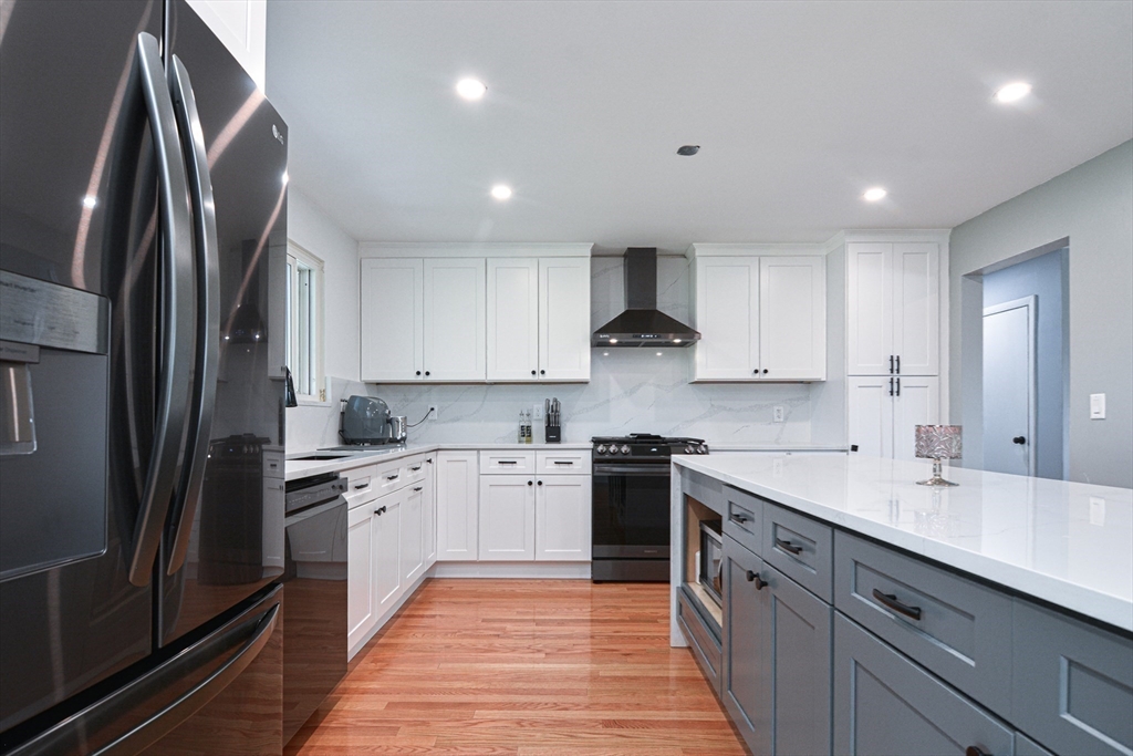 35 Worcester Street Methuen, MA 01844 - Photo 4 of 31 a kitchen with stainless steel appliances granite countertop a sink stove and refrigerator