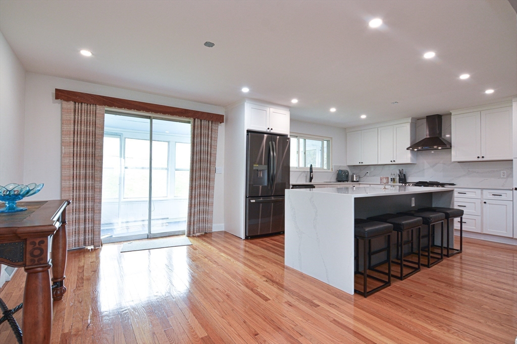 35 Worcester Street Methuen, MA 01844 - Photo 5 of 31 a kitchen with stainless steel appliances granite countertop a refrigerator a stove top oven and wooden floors