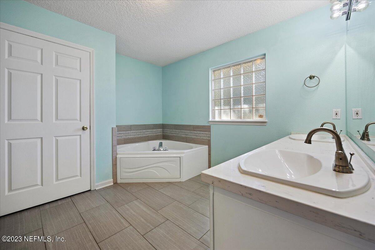 369 Owen Acres Drive Macclenny, FL 32063 - Photo 12 of 21 a bathroom with a sink a vanity and tub
