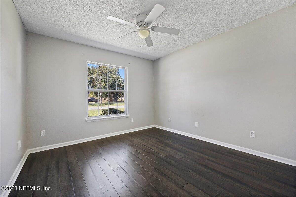 369 Owen Acres Drive Macclenny, FL 32063 - Photo 15 of 21 wooden floor in an empty room with a window