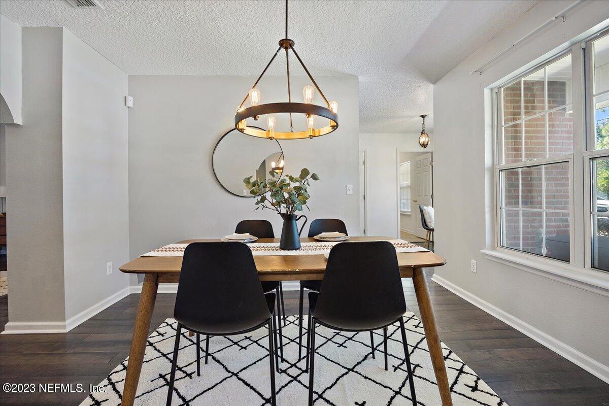 369 Owen Acres Drive Macclenny, FL 32063 - Photo 4 of 21 a dining room with chandelier and wooden floor