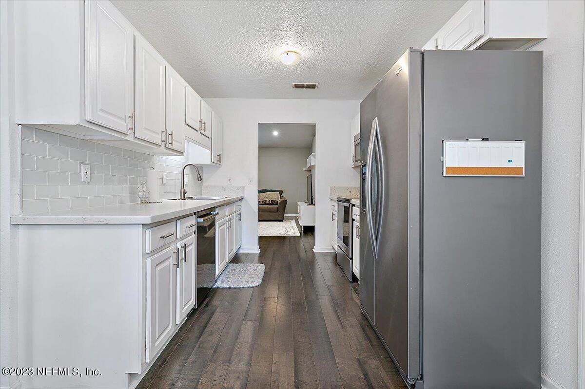 369 Owen Acres Drive Macclenny, FL 32063 - Photo 5 of 21 a kitchen with stainless steel appliances granite countertop a refrigerator and a stove