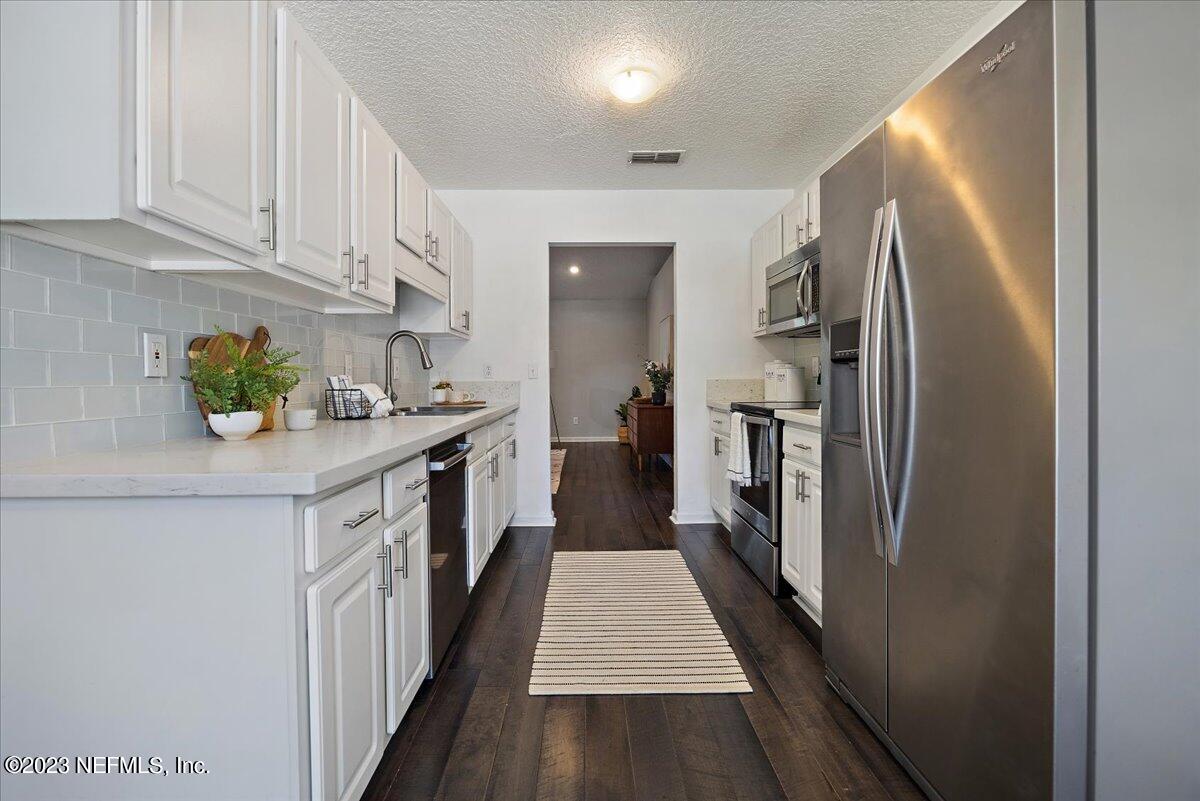 369 Owen Acres Drive Macclenny, FL 32063 - Photo 6 of 21 a kitchen with stainless steel appliances granite countertop a refrigerator a stove and a sink