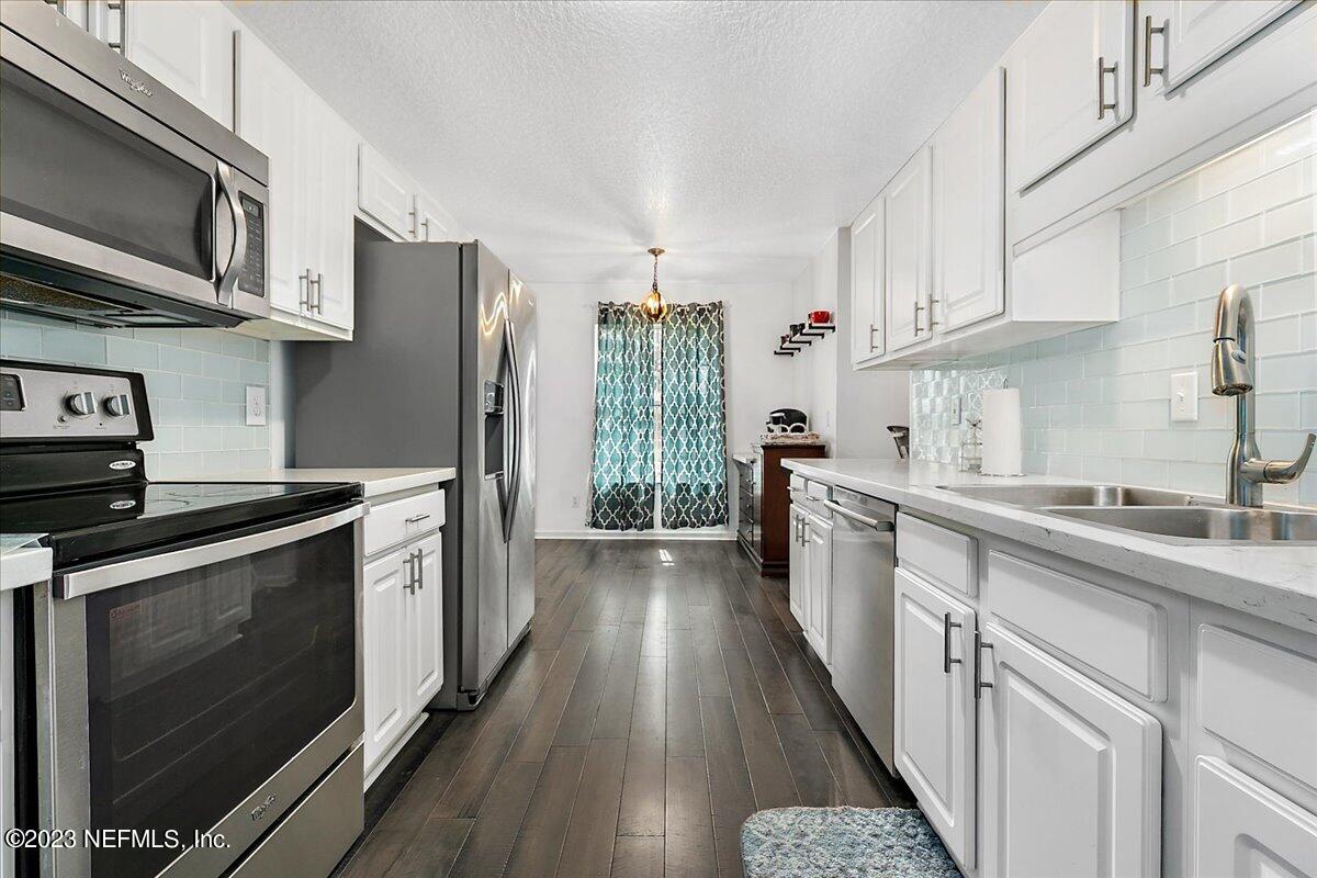 369 Owen Acres Drive Macclenny, FL 32063 - Photo 7 of 21 a kitchen with stainless steel appliances a stove a sink and a refrigerator
