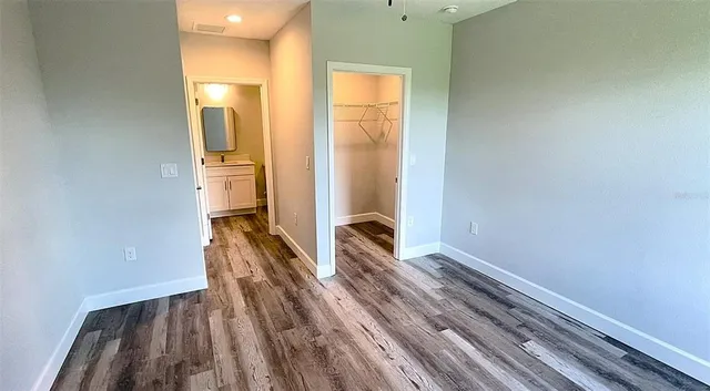 a view of hallway with wooden floor
