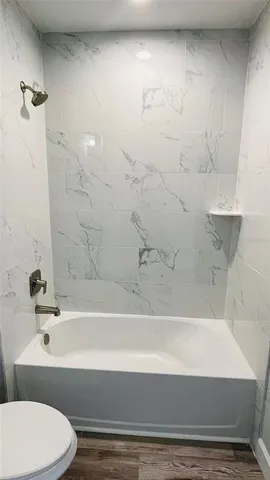 a white toilet sitting next to a bathroom sink