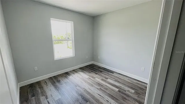 a view of a room with wooden floor and staircase