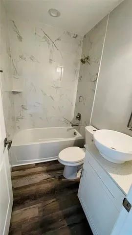 a bathroom with a toilet a sink and bathtub