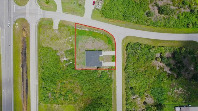 a yellow and red house with a garden