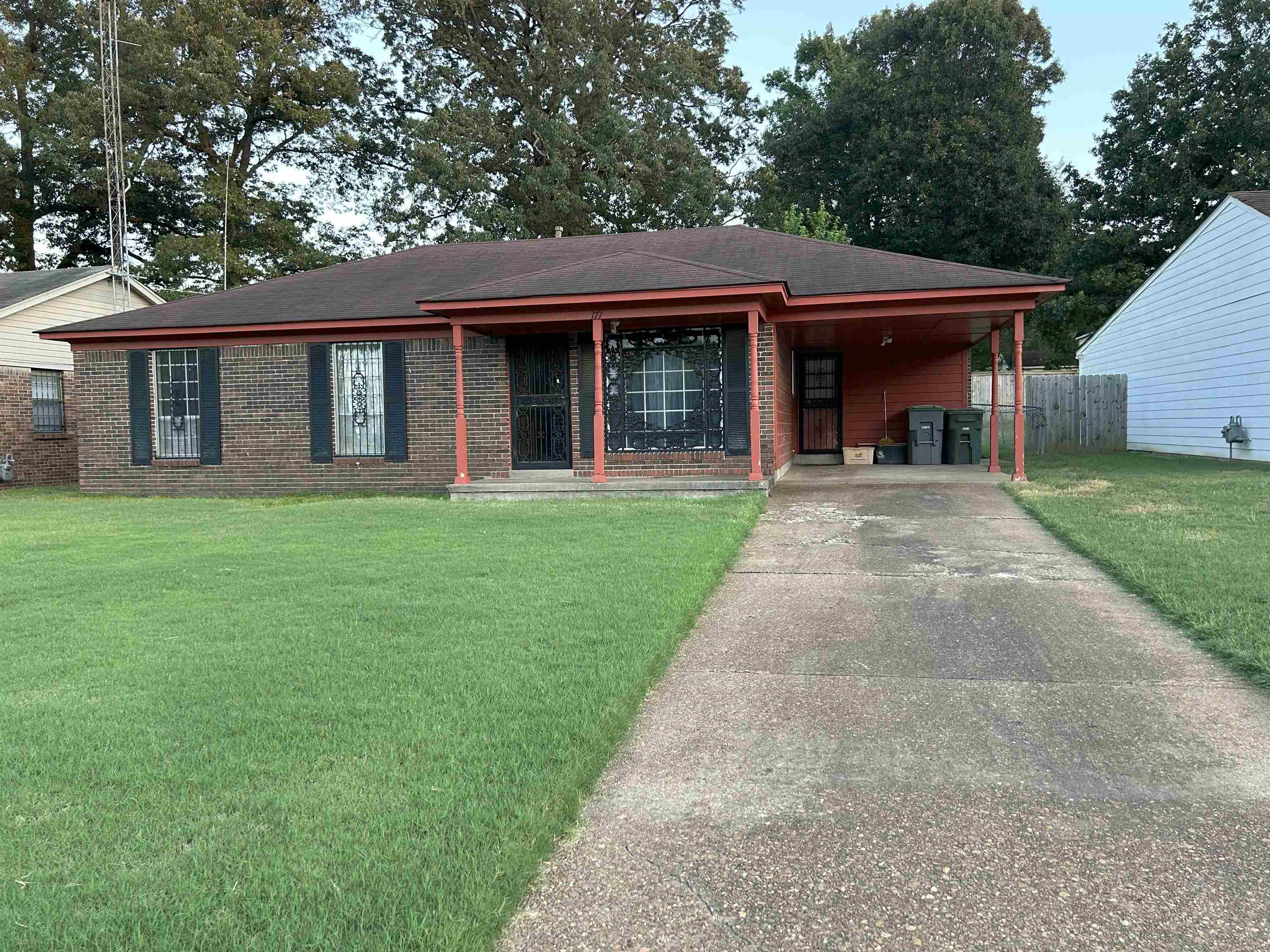 a front view of a house with yard and porch