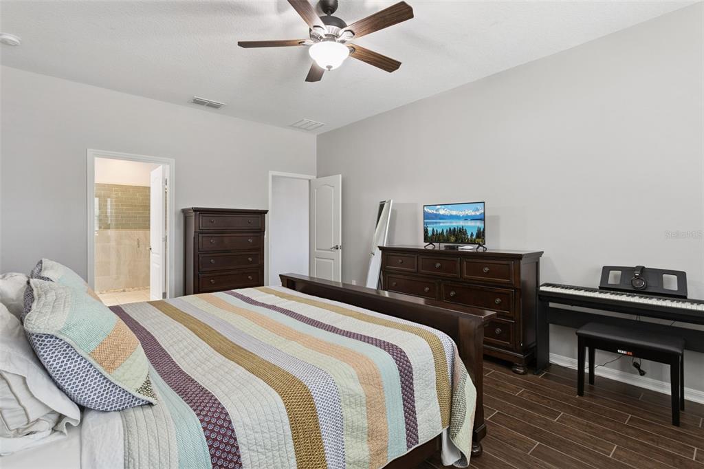 2400 Artist Point Court Apopka, FL 32703 - Photo 15 of 50 a bedroom with a bed and a dresser