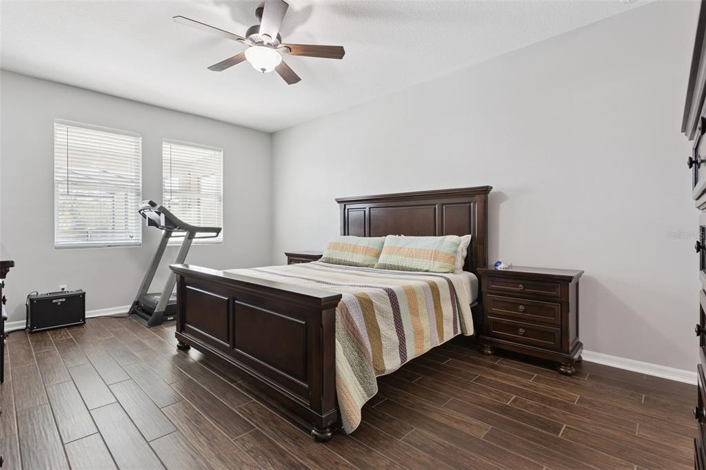 2400 Artist Point Court Apopka, FL 32703 - Photo 16 of 50 a bedroom with a bed and wooden floor