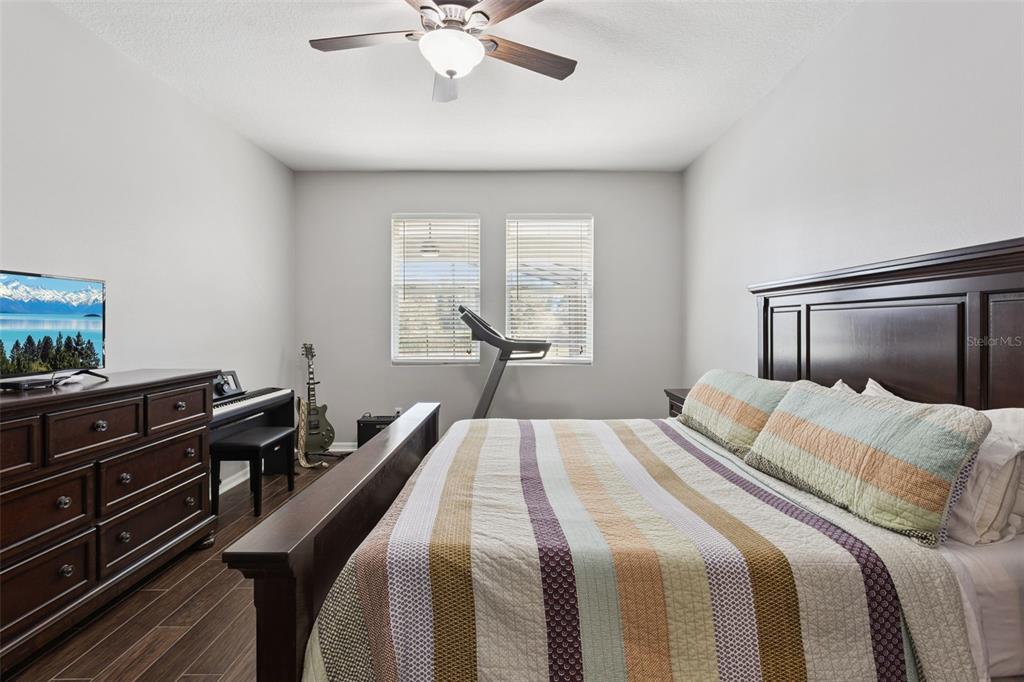 2400 Artist Point Court Apopka, FL 32703 - Photo 17 of 50 a bedroom with a bed and wooden floor